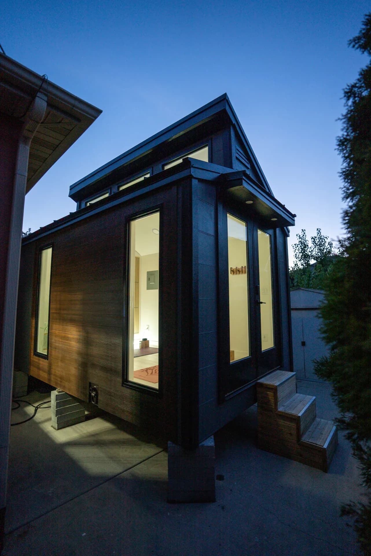 Sauna Haus side angle at dusk showing wood and glass